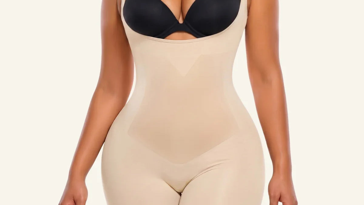 Beige SHAPERX X-Panel open-bust mid-thigh bodysuit worn with a separate black bra
