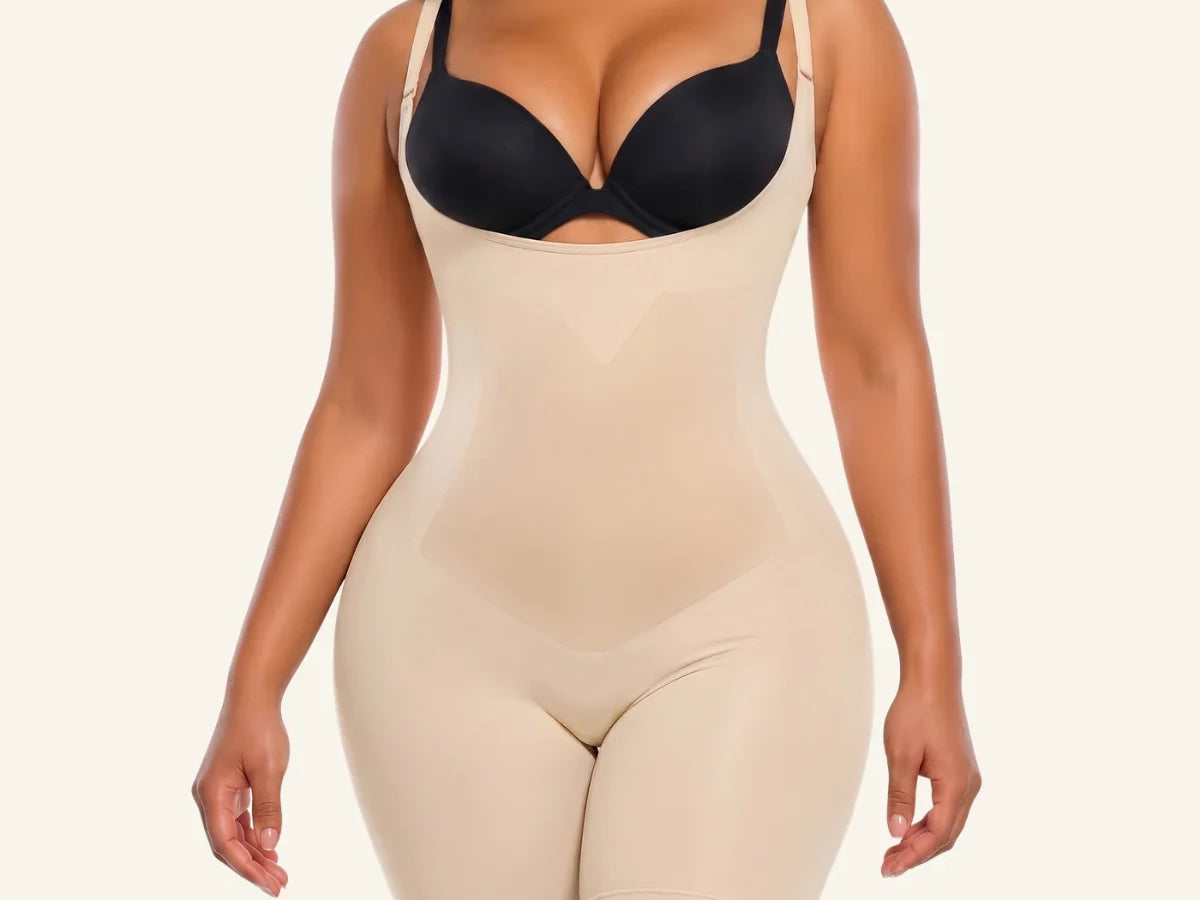 Beige SHAPERX X-Panel open-bust mid-thigh bodysuit worn with a separate black bra