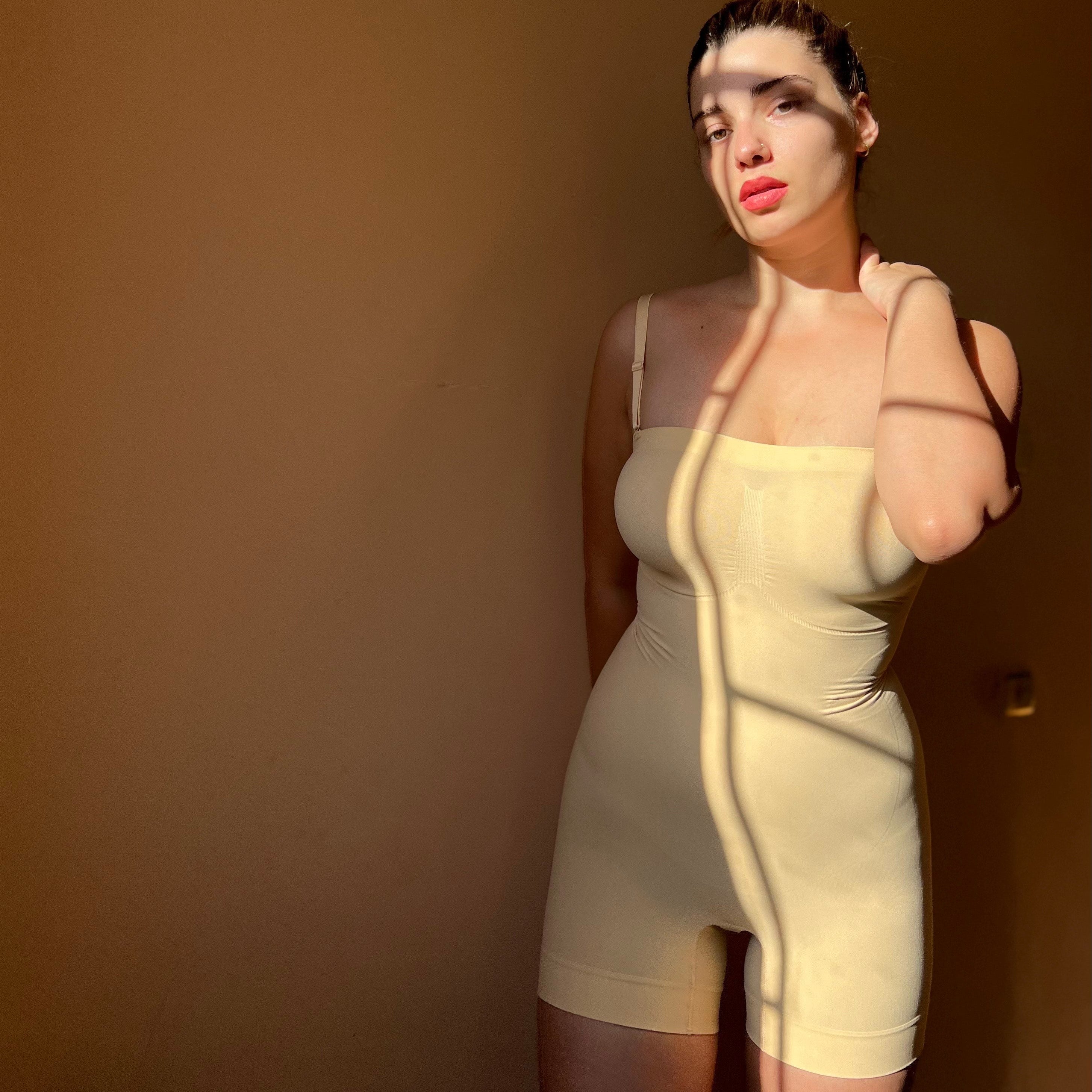Woman wearing ShaperX seamless tummy control bodysuit in beige