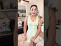 Model wearing beige tummy control shapewear bodysuit with front closure detail
